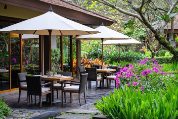 Fototapeta premium There is an outdoor lounge and restaurant near the pool and there is a view of the garden