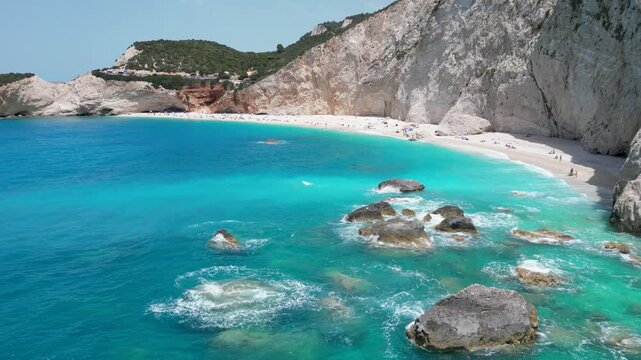 Porto Katsiki Beach on the Greek island of Lefkada, with a mountain and people on the beach