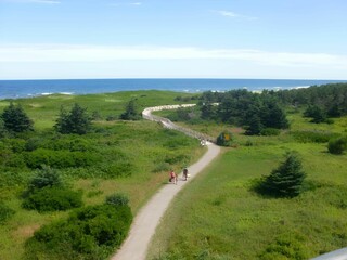 Scenic view of a coastal path with people walking, Greenwich National Park on Prince Edward Island