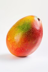 A fresh mango sitting alone on a white surface