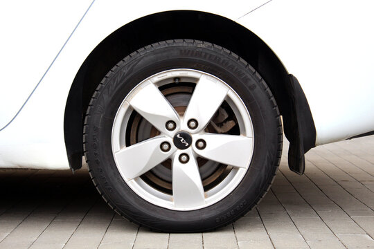 Vinnytsia, Ukraine; September 04, 2024. White Kia Ceed wheel. Korean car Kia Ceed front wheel. Kia light alloy wheel. Firestone Winter tires on Kia Ceed.