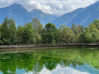 Fototapeta premium Small reservoir Plužna or Pluzensko lake, stream Gljun (Bovec, Slovenia) - Kleiner Stausee Pluzna, Bach Glijun (Bovec, Slowenien) - Akumulacijsko jezero Plužna or Plužensko jezero (Slovenija)