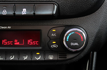 Fototapeta premium Air conditioning of car. Car air conditioner is on. Detail air conditioning button inside car. Dual-zone car climate control. Climate control dashboard display. Modern vehicle air conditioner.