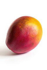 A single ripe mango placed on a clean white surface