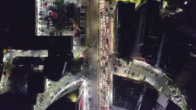 Drone footage of night traffic in a main road between the buildings in Gulshan, Dhaka, Bangladesh
