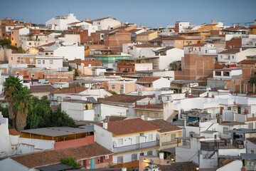 A scenic view of a densely packed residential area with various buildings and houses during sunset