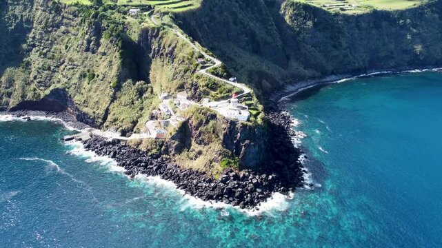 Aerial footage of the Arnel Point Lighthouse, on a sunny day in Sao Miguel island, Azores, Portugal