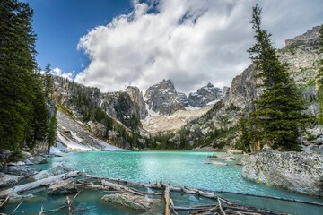 Stunning mountain landscape with turquoise Lake Delta and a cloudy sky in Grand Teton Wyoming