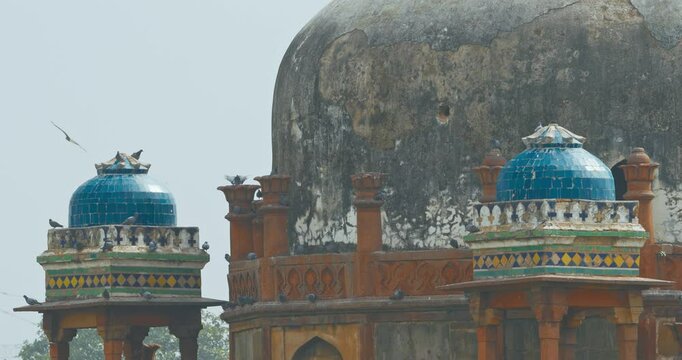 New Delhi, Delhi, India. Doves birds flying above Babur's Tomb near The Humayun's tomb. Famous place is Tomb of Mughal emperor, Mirza Nasir al-Din Muhammad commonly known as Humayun situated in Delhi