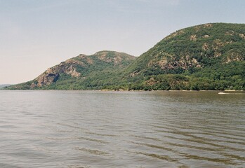 Scenic view of the Hudson River surrounded by lush green trees on a sunny summer day