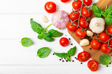 Fresh cherry tomatoes and fresh green basil on a textured background. Tomato sauce. Vegan. Ingredients for salad. Organic food. Place for text. Copy space.