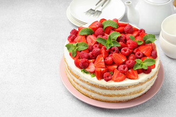 Tasty sponge cake with fresh berries and mint on light gray table, space for text