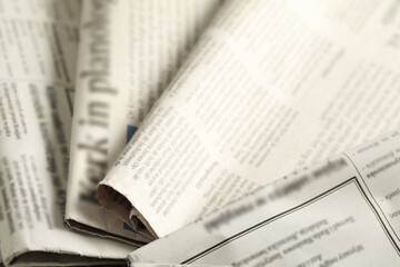 Fototapeta premium Many newspapers in different languages as background, closeup