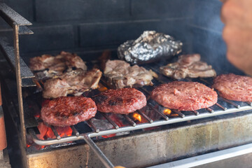 Closeup grill hamburgers on metal net on open fire