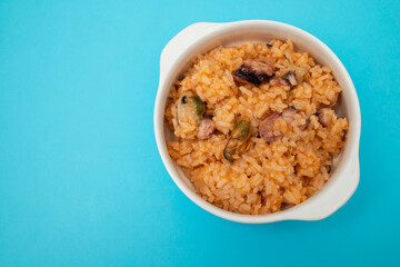 traditional portuguese dish rice with seafood in white dish
