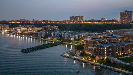 City waterfront at dusk with lights reflecting on water