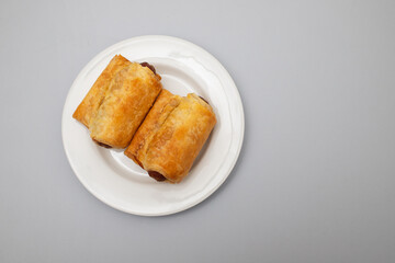 Mini sausages in dough on small plate
