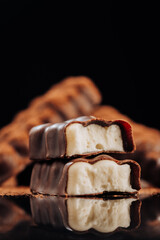 Chocolate bar with creamy filling on dark background, ideal for dessert and confectionery concepts