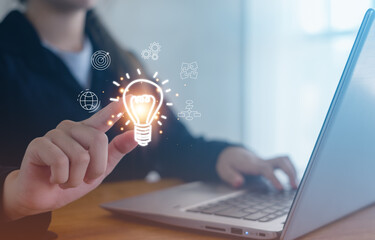  Hand of woman holding illuminated light bulb, Concept for success. Idea innovation and inspiration concept.creativity with bulbs that shine glitter.