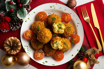 Vegan Chickpea balls coated with panko. Top view table with christmas decoration.