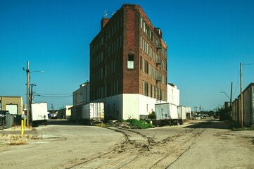 Urban industrial area with brick building and trailers