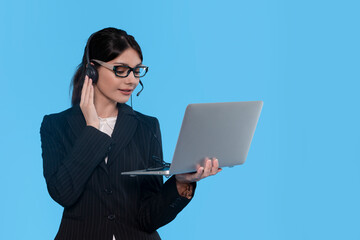 Woman in Headset Joins Virtual Meeting Against Bright Blue Backdrop