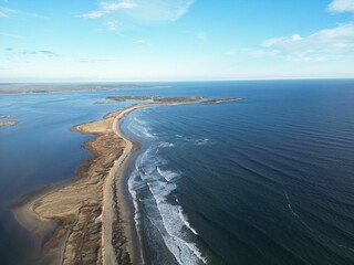 Aerial view of a coastal landscape with clear blue ocean.