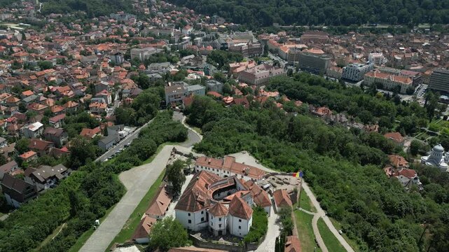 Aerial footage of the Fortress-on-Straja (Cetatuia de pe Straja) on a sunny day in Brasov, Romania