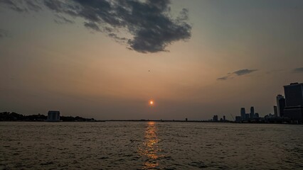 Sunset over the water with city skyline