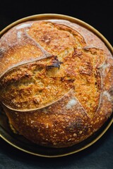 Boule of sourdough on brass tray