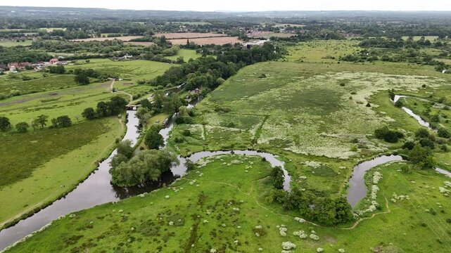 Drone of the Wey Navigation winds through the Surrey countryside at Ripley at a daytime in England