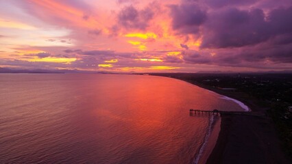 Vibrant sunset over beach and pier