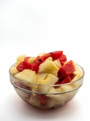 Glass bowl with fresh watermelon and pineapple chunks.