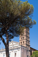 Church with bell tower and tree under blue sky