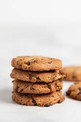 stacked chocolate chip cookies  on light background