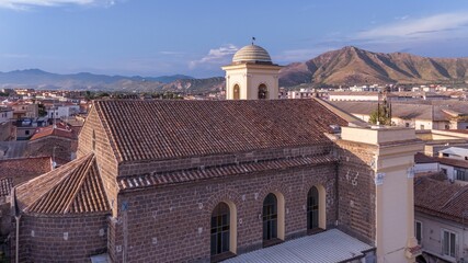 Aerial of the church of St. Erasmus in Santa Maria Capua Vetere with mountains in the background
