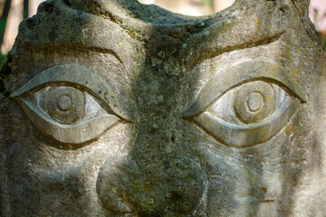 The figure of the ancient gods on the stones in the autumn park. Ukraine. Scythian culture