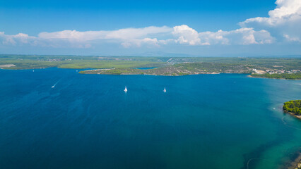 An aerial view of the stunning Krka Canyon located between Šibenik and Bilice in Croatia. The canyon winds through lush landscapes and dramatic cliffs, with the Krka River 