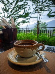 A Cup of Black Coffee With A Mountain View