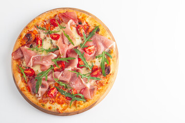 Pizza with prosciutto, ham, arugula, spinach, tomatoes, pesto, cheese and parmesan. Italian cuisine. 