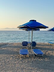 Pebble beach with parasols and sun beds