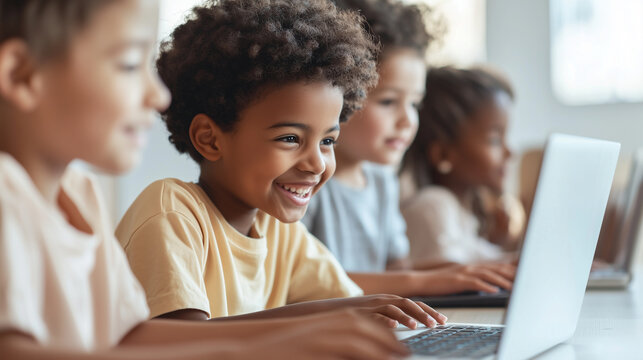 Smiling elementary students huddled together at their teacher's desk, focused on a laptop as they explore educational online programs during class. photo - Powered by Adobe