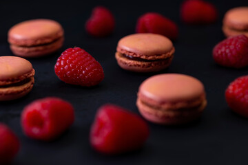 macaroons of different colors on a black background