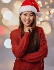 Portrait of beauty Asian woman wearing Santa-Claus hat with happy expression for Christmas celebration on bright background