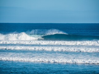Surfer riding a wave in the ocean