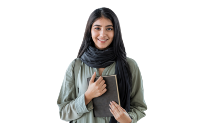 Portrait of a smiling young Middle Eastern female college student holding a book, isolated on transparent background