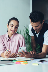 Multiethnic young coworkers working at table