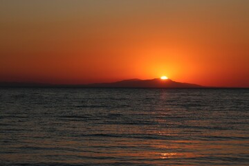 Beautiful sunset looking at an island from a beach in Turkey
