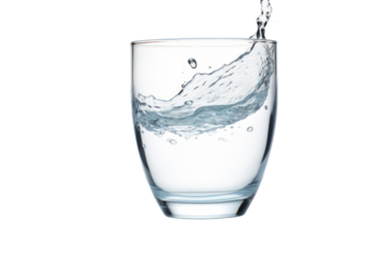 Close-up of water pouring into a transparent glass with droplets splashing around isolated on white background