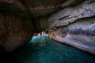 Inside view of a cave with turquoise waters on the shore of the Ionian island of Zakynthos, Greece